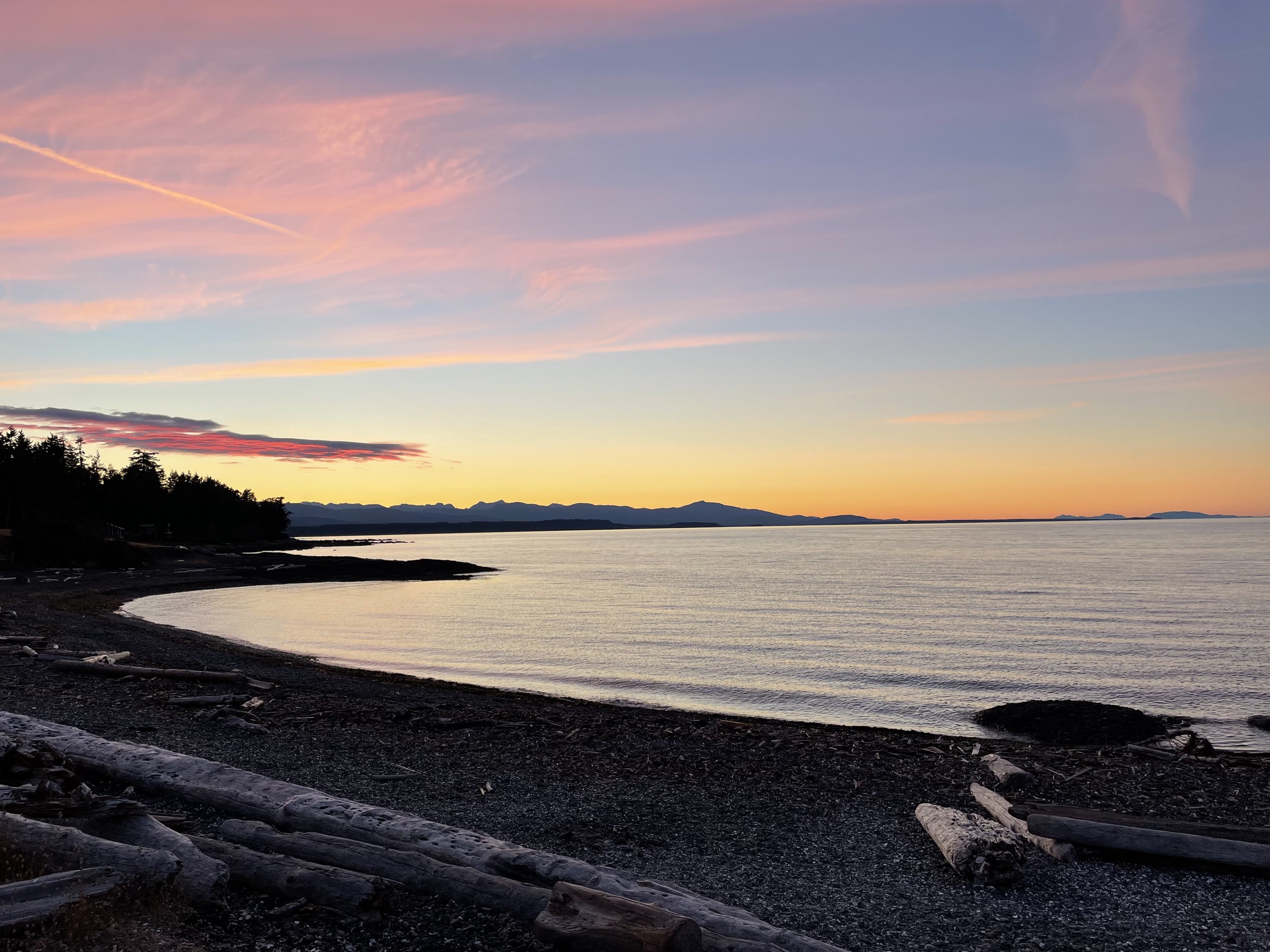 Soft pink sunset over a peaceful coastal shoreline